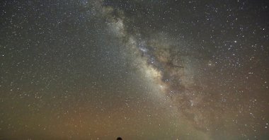 The Milky Way is seen in the night sky around telescopes and camps of people over rocks in the White Desert north of the Farafra Oasis southwest of Cairo, Egypt, May 16, 2015. (Reuters Photo)