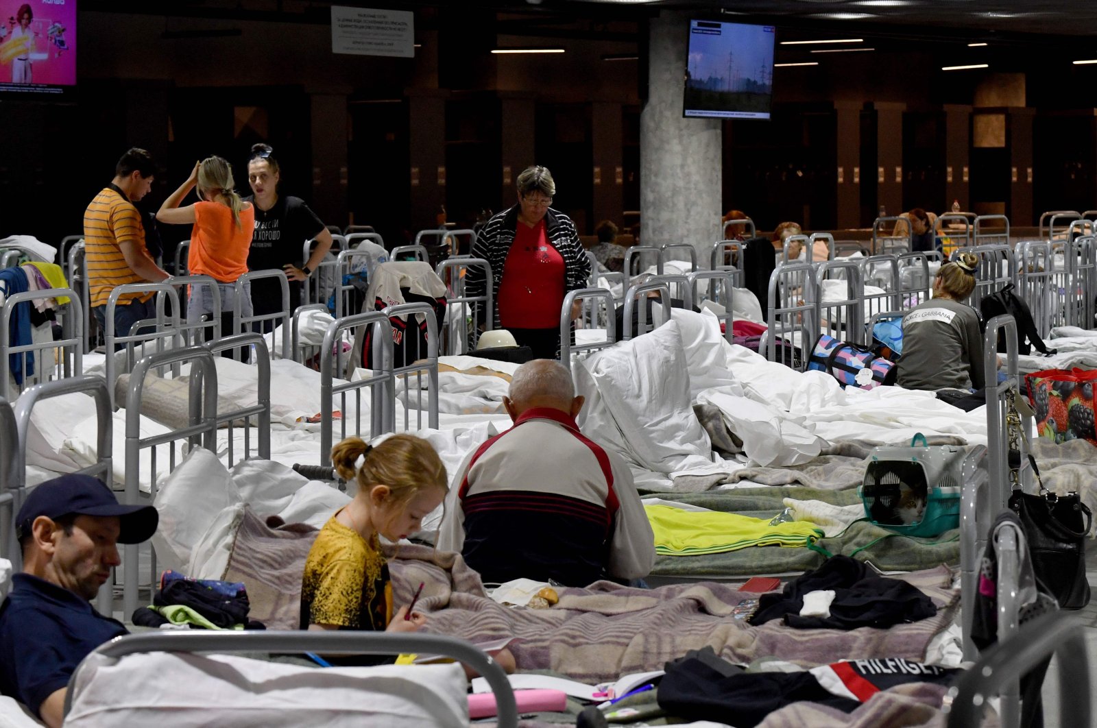 Residents, including those evacuated from the town of Shebekino, are seen settled in a temporary shelter set up at the Belgorod Arena in the regional capital of Belgorod on June 2, 2023. (AFP Photo)