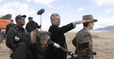 This image released by Universal Pictures shows director Christopher Nolan (C) and Cillian Murphy (R) on the set of "Oppenheimer." (AP Photo)