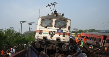 Rescue workers and military personnel gather around damaged carriages at the accident site of a three-train collision near Balasore, Odisha, India, June 3, 2023. (AFP Photo)
