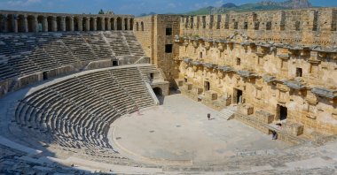 Tourists visit the Aspendos,Theater, in Antalya, Türkiye, June 10, 2018. (Shutterstock Photo)