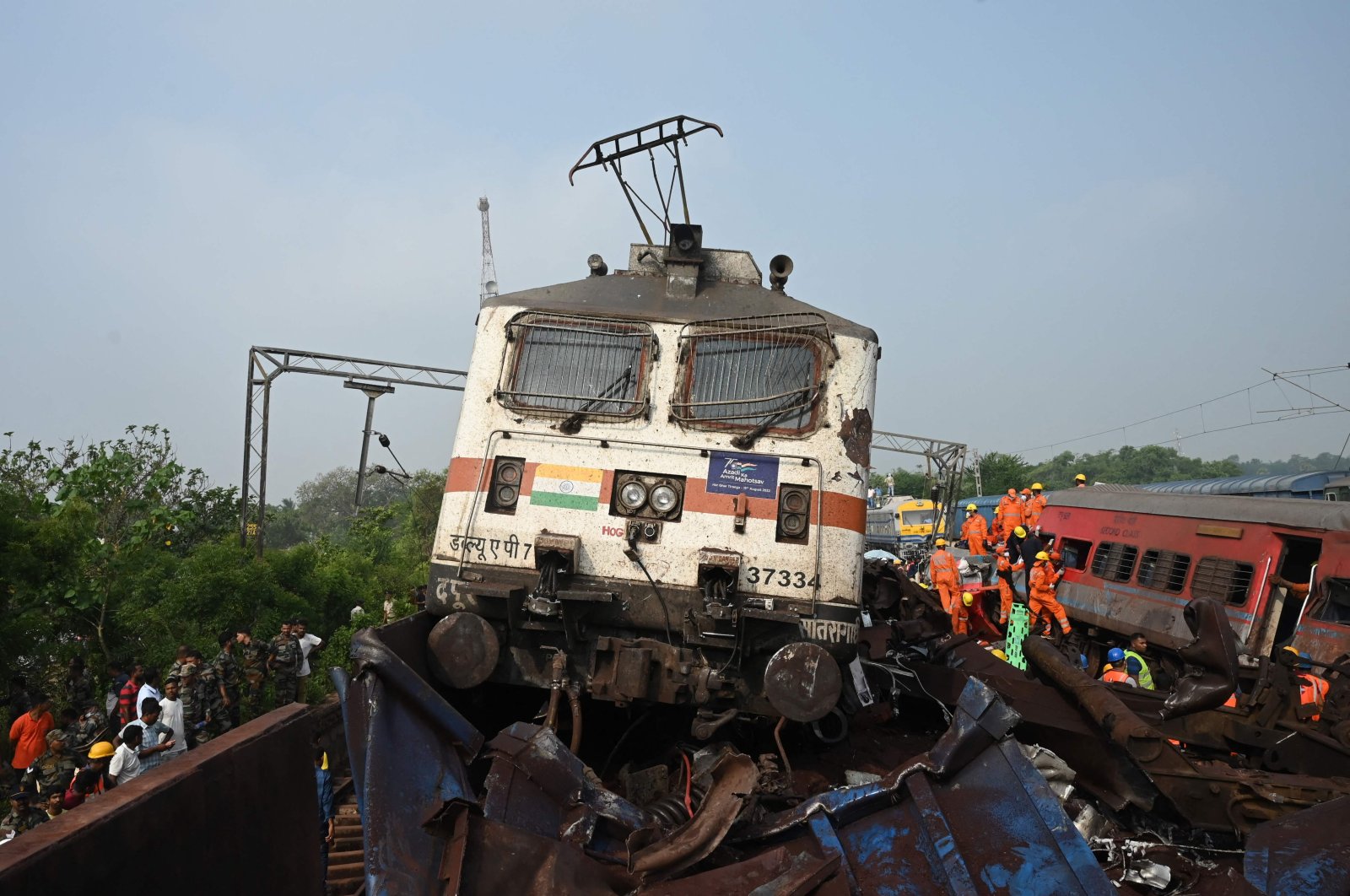Rescue workers and military personnel gather around damaged carriages at the accident site of a three-train collision near Balasore, Odisha, India, June 3, 2023. (AFP Photo)
