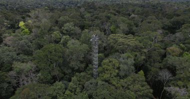 Workers survey a tower that will be part of a complex of towers arrayed in six rings to spray carbon dioxide into the rainforest north of Manaus, Brazil, May 23, 2023. (AP Photo)