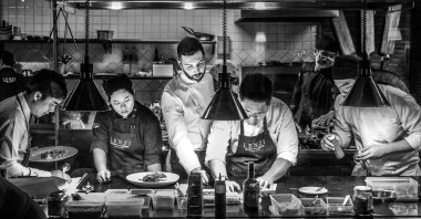 A head chef coaches his team in a busy Italian Tuscan kitchen, in Bangkok, Thailand, Jan. 16, 2016. (Shutterstock Photo)