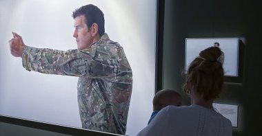 A visitor looks at a display featuring decorated war veteran Ben Roberts-Smith at the Australian War Memorial in Canberra, Australia, June 2, 2023. (AP Photo)