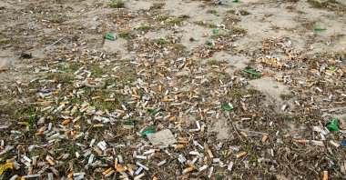 Cigarette butts are seen on the ground, June 05, 2023. (Shutterstock Photo)