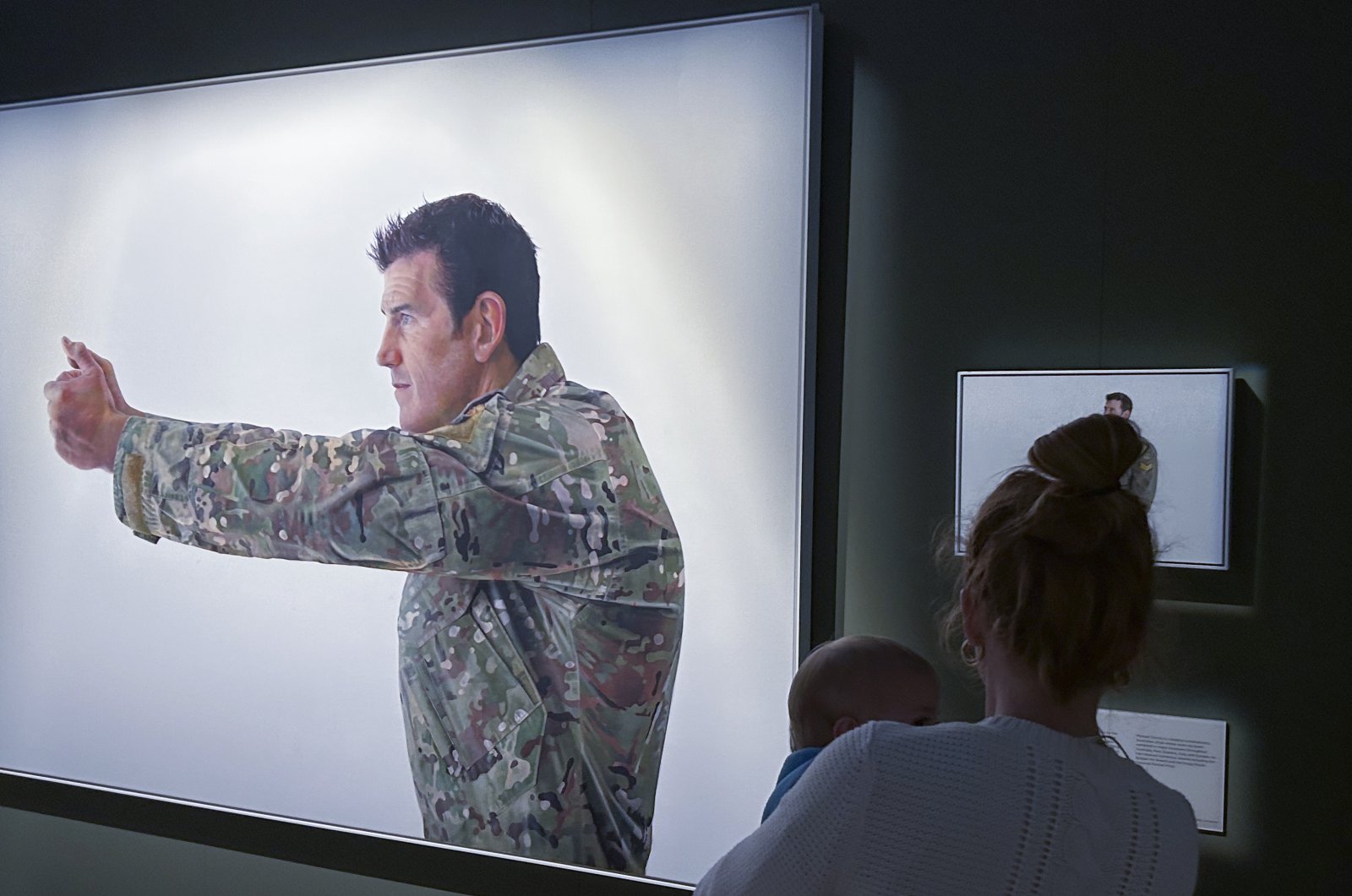 A visitor looks at a display featuring decorated war veteran Ben Roberts-Smith at the Australian War Memorial in Canberra, Australia, June 2, 2023. (AP Photo)