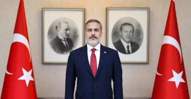 The newly appointed Foreign Minister Hakan Fidan is posing in front of portraits of Mustafa Kemal Atatürk, the founder of the Republic of Türkiye, and President Recep Tayyip Erdoğan, Ankara, Türkiye, June 5, 2023. (AA Photo) 