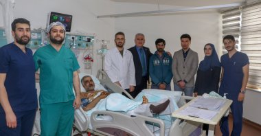 Pakistani volunteer Mashan, 58 is photographed alongside a medical team at Erzurum Atatürk University Research Hospital, Eruzurm, eastern Türkiye, June 6, 2023. (AA Photo)