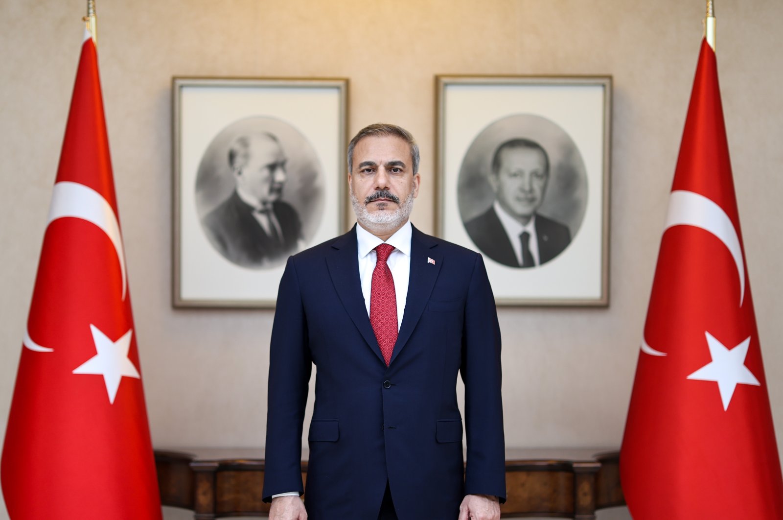 The newly appointed Foreign Minister Hakan Fidan is posing in front of portraits of Mustafa Kemal Atatürk, the founder of the Republic of Türkiye, and President Recep Tayyip Erdoğan, Ankara, Türkiye, June 5, 2023. (AA Photo) 