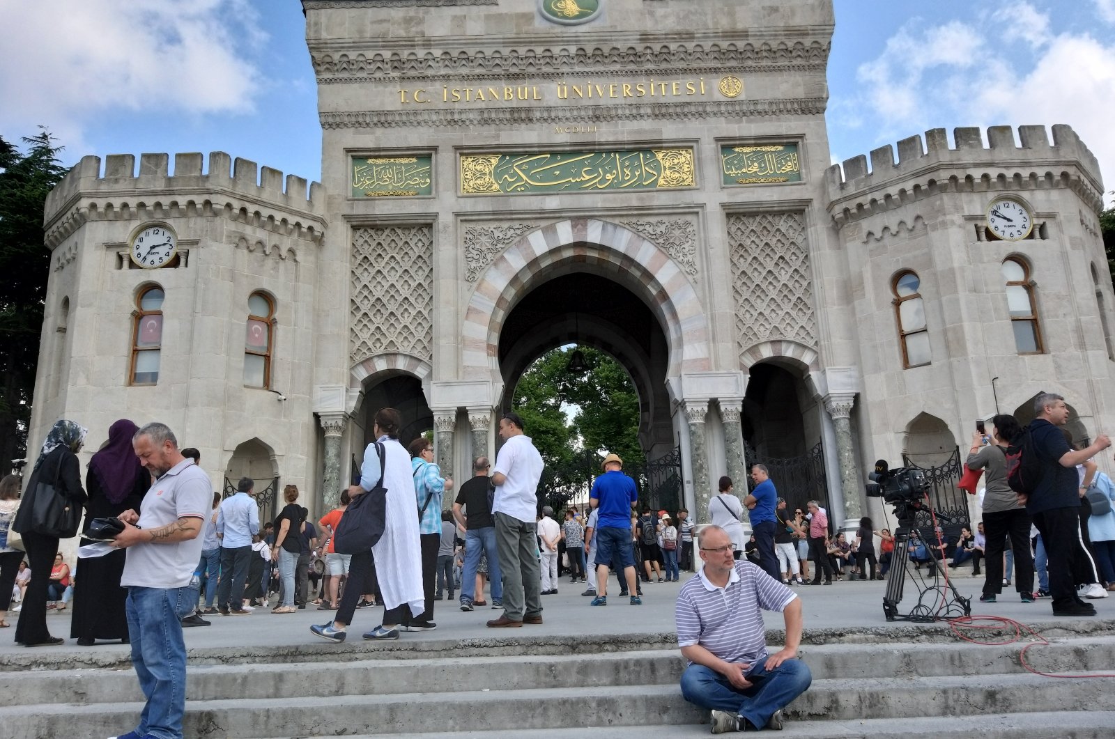 Students and parents wait in front of the Istanbul University entrance gate during the YKS exam, Istanbul, Türkiye, June 17, 2019. (AA Photo)
