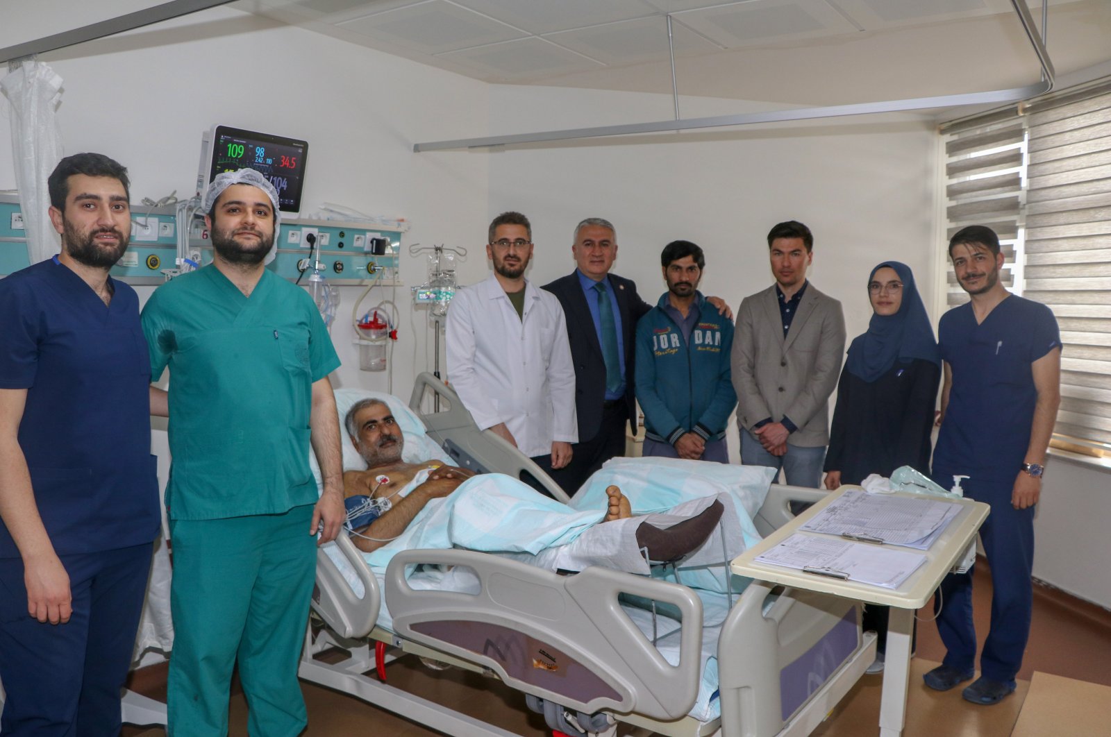Pakistani volunteer Mashan, 58 is photographed alongside a medical team at Erzurum Atatürk University Research Hospital, Eruzurm, eastern Türkiye, June 6, 2023. (AA Photo)