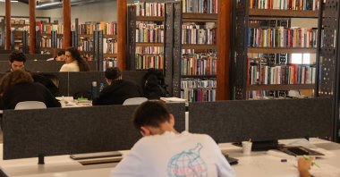 A young man is photographed reading in a library in Izmir, western Türkiye, May 11, 2023. (AA Photo)