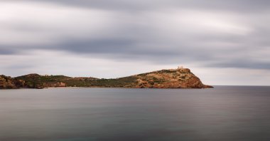 The Temple of Poseidon at Sounio, Greece against a cloudy sky, shot taken from across the bay, in this undated file photo. (Shutterstock File Photo)