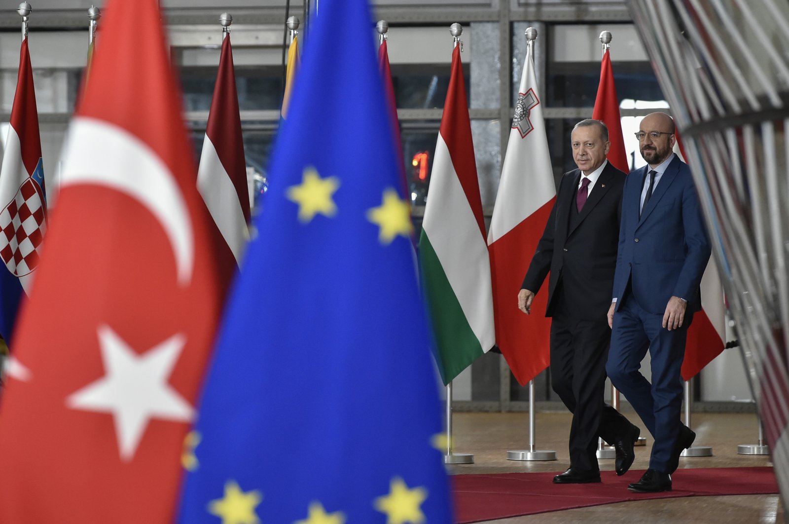 President Recep Tayyip Erdoğan walks with European Council President Charles Michel as he arrives at the European Council building in Brussels, Monday, March 9, 2020. (AP File Photo)