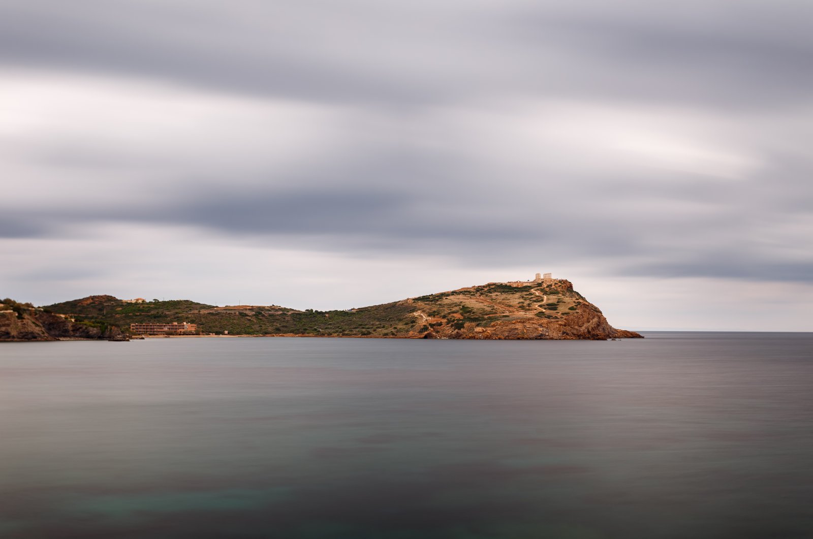 The Temple of Poseidon at Sounio, Greece against a cloudy sky, shot taken from across the bay, in this undated file photo. (Shutterstock File Photo)