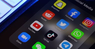 Social media application icons are seen on a smart phone screen. (Shutterstock Photo)