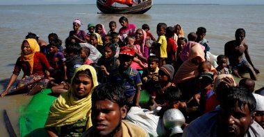 Rohingya refugees sit on a makeshift boat as they get interrogated by the Border Guard Bangladesh after crossing the Bangladesh-Myanmar border, Cox's Bazar, Bangladesh, Nov. 9, 2017. (Reuters Photo)