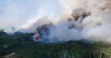 Smoke rises above the southeast perimeter of the Paskwa fire as it burns near Fox Lake, Alberta, Canada, May 16, 2023. (Reuters Photo)