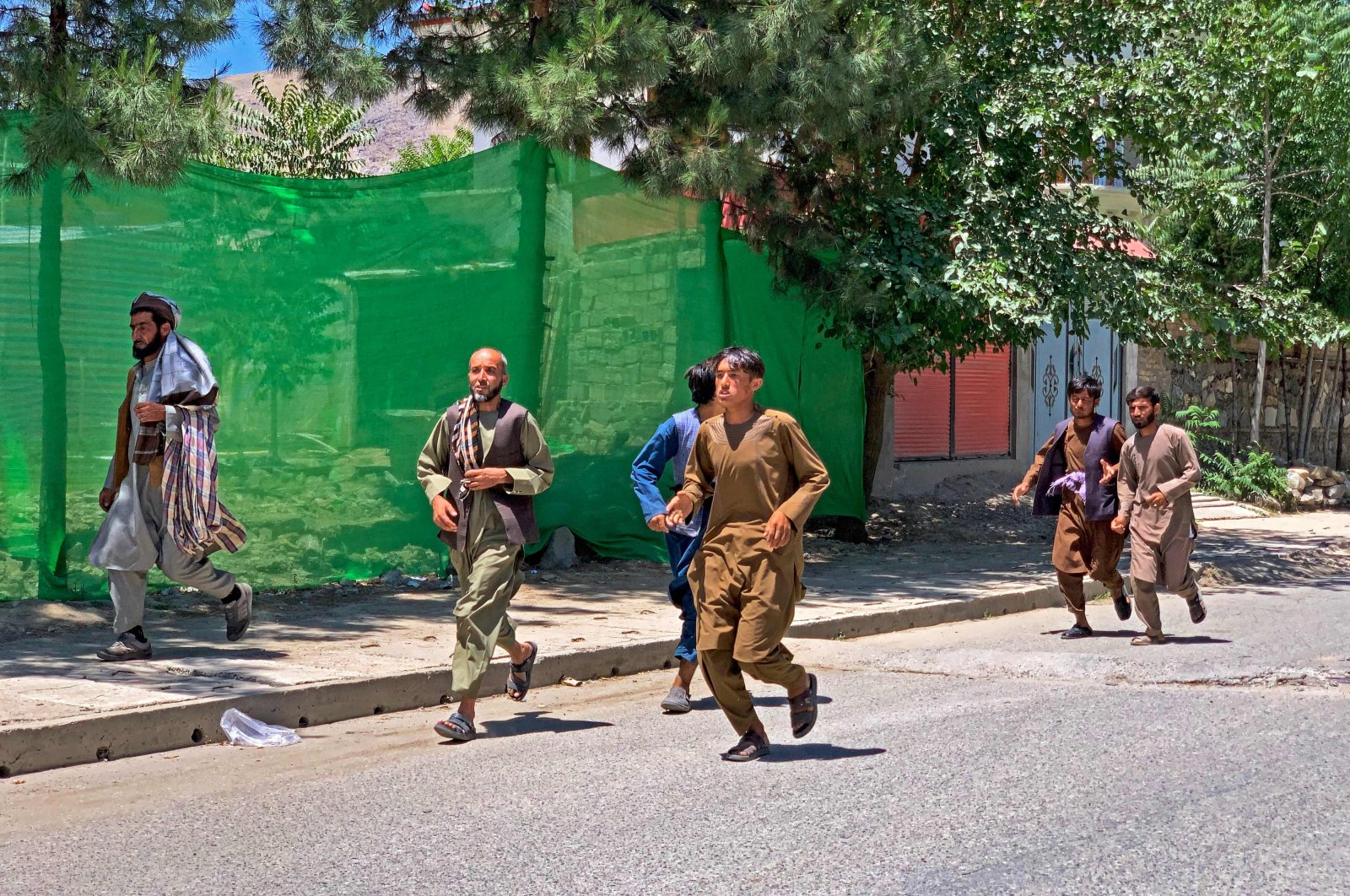 People run away after a bomb explosion at a funeral in the Hesa-e-Awal area of Fayzabad district, Badakhshan province, Afghanistan, June 8, 2023. (AFP Photo)