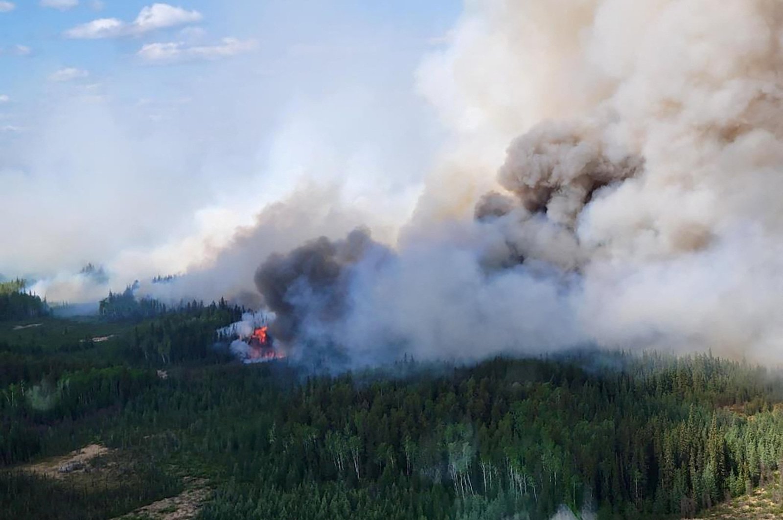 Smoke rises above the southeast perimeter of the Paskwa fire as it burns near Fox Lake, Alberta, Canada, May 16, 2023. (Reuters Photo)