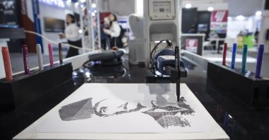Artificial intelligence-supported Mitsubishi Electric's collaborative robot Melfa Assista is seen painting the picture of Kemal Atatürk, founder of the Turkish republic, Istanbul, Türkiye, June 8, 2023. (AA Photo)