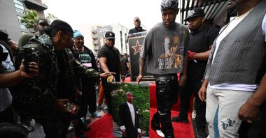 Rapper YG holds a portrait of rapper Tupac Shakur, during Tupac&#039;s Hollywood Walk of Fame star ceremony in Hollywood, California, U.S., June 7, 2023. (AFP Photo)