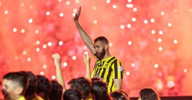 Former Real Madrid striker Karim Benzema, surrounded by children taking part in a ceremony, waves to the crowd at Al-Ittihad&#039;s stadium in Jeddah, Saudi Arabia, June 8, 2023. (AFP Photo)