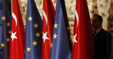 An official adjusts Turkish and European Union flags prior to the opening session of a high-level meeting between the EU and Türkiye, Istanbul, Türkiye, Feb. 28, 2019. (AP File Photo)
