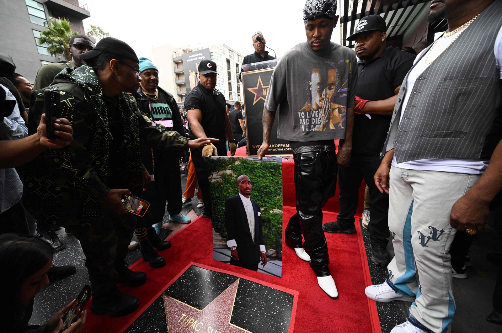 Rapper YG holds a portrait of rapper Tupac Shakur, during Tupac&#039;s Hollywood Walk of Fame star ceremony in Hollywood, California, U.S., June 7, 2023. (AFP Photo)