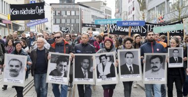 People carry photos of NSU victims in a protest, in Kassel, Germany, April 6, 2017. (AP Photo) 