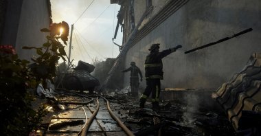 Rescuers work at a site of a private house heavily damaged in a Russian shelling, during the evacuation of local residents from a flooded area after the Nova Kakhovka dam breached, amid Russia's attack on Ukraine, Kherson, Ukraine, June 9, 2023. (Reuters Photo)