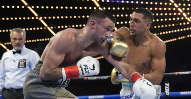 Teofimo Lopez (R) punches Scotland's Josh Taylor during the third round of a welterweight title bout, New York, US., June 10, 2023. (AP Photo)