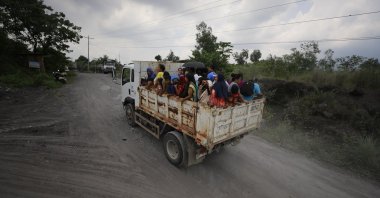 Filipino villagers living at the foot of the Mayon volcano ride a truck during a mass evacuation in Guinobatan town, Albay province, Philippines, June 9, 2023. (EPA Photo)