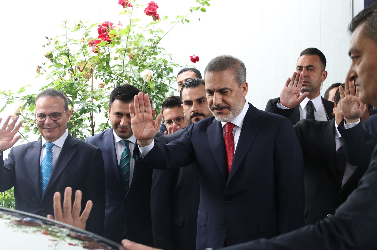 Hakan Fidan (C) waves goodbye to his predecessor Mevlüt Çavuşoğlu, in the capital Ankara, Türkiye, June 5, 2023. (AFP Photo) 