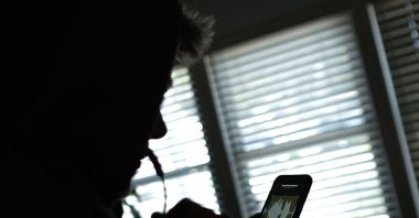 The illustration shows a person using a smartphone to record a voice message in Los Angeles, U.S., June 9, 2023. (AFP Photo)