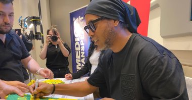 Former Brazil football player Ronaldinho signs autographs after a hair care procedure at Cosmedica, Istanbul, Türkiye, June 12, 2023. (DHA Photo)