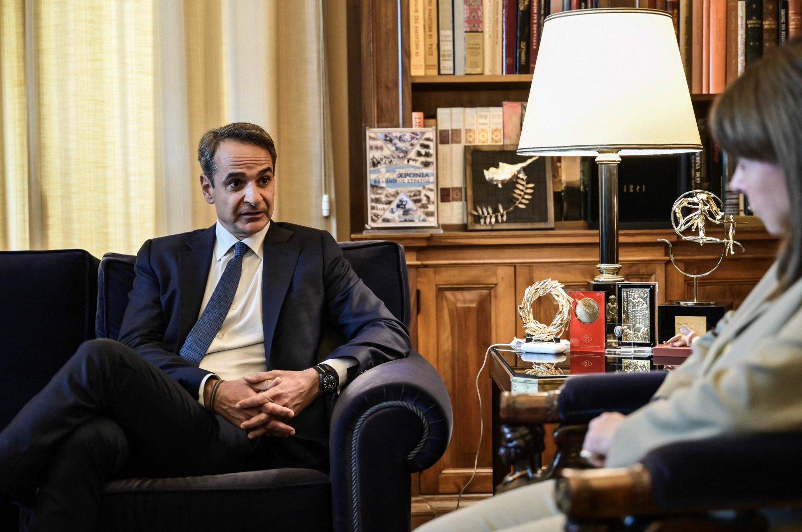 Greek Prime Minister Kyriakos Mitsotakis (L) speaks with Greek President Katerina Sakellaropoulou ahead of their meeting at the Presidential Palace in Athens, on May 22, 2023. (AFP File Photo)