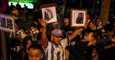 Chinese fans react after they catch a glimpse of the Argentine national football team outside a hotel where the team is staying, Beijing, China, June 12, 2023. (AFP Photo)