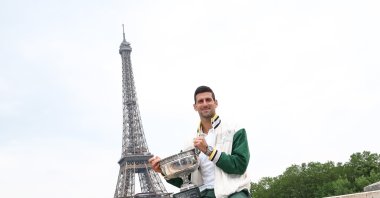 Novak Djokovic of Serbia poses with the Coupe des Mousquetaires after winning the Men&#039;s final match at the Roland Garros French Open tennis tournament, at Pont de Bir-Hakeim near the Eiffel Tower, Paris, France, June 12, 2023. (EPA Photo)