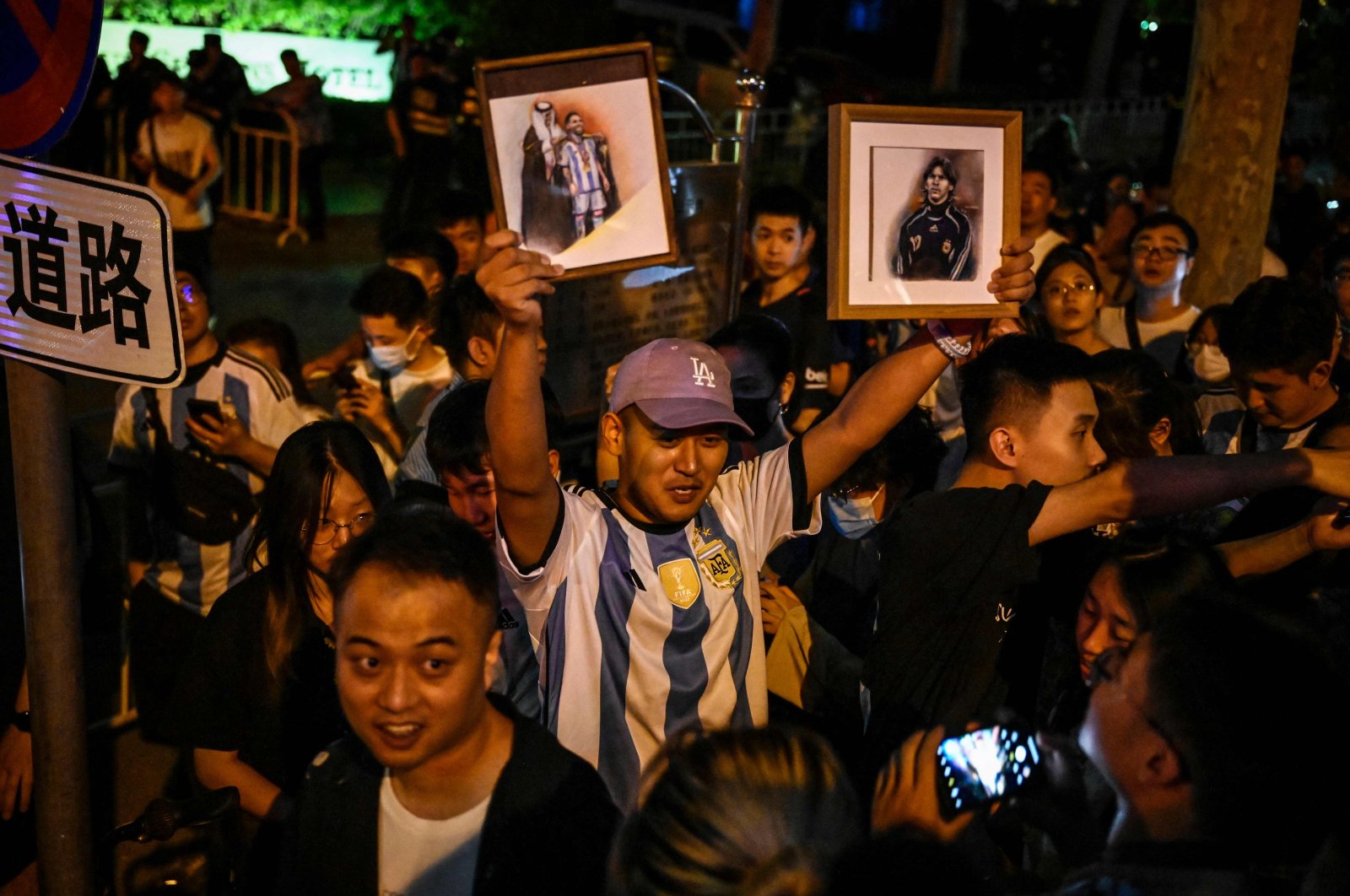 Chinese fans react after they catch a glimpse of the Argentine national football team outside a hotel where the team is staying, Beijing, China, June 12, 2023. (AFP Photo)