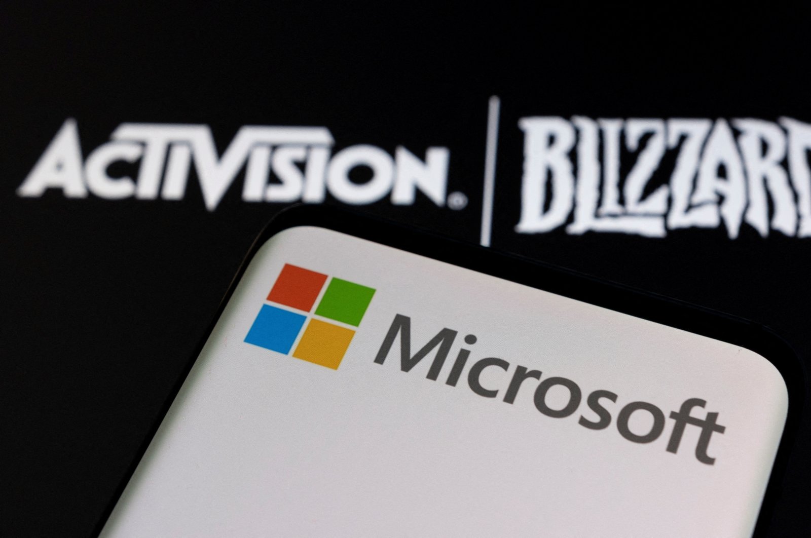 Microsoft logo on a smartphone placed on displayed Activision Blizzard logo in an illustration dated January 18, 2022. (REUTERS/Dado Ruvic/Illustration/File Photo)