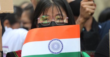 A woman holds the Indian flag, as members of the Kuki tribe take part in a tribal solidarity protest against the alleged ethnic cleansing in Manipur state, New Delhi, India, May 31, 2023. (EPA Photo)