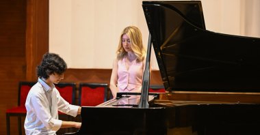 Efe Öksüz, 15, is photographed playing piano along with his mentor, Izmir, western Türkiye, June 14, 2023. (AA Photo)