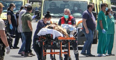 Medics carry a survivor on a stretcher after a boat carrying dozens of migrants sank in in the Ionian Sea near Greece, June 14, 2023. (AFP Photo)
