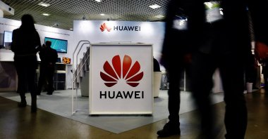Visitors walk past the Huawei logo at the World Artificial Intelligence Cannes Festival (WAICF), Cannes, France, Feb. 10, 2023. (Reuters Photo)