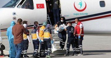 The air ambulance teams are photographed entering the plane in an undisclosed location, June 16, 2023. (Courtesy of Sabah newspaper)