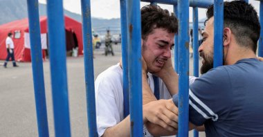 Syrian survivor Mohammad, 18, who was rescued with other refugees and migrants at open sea off Greece after their boat capsized, cries as he reunites with his brother Fadi, who came to meet him from the Netherlands, Kalamata, Greece, June 16, 2023. (Reuters Photo)