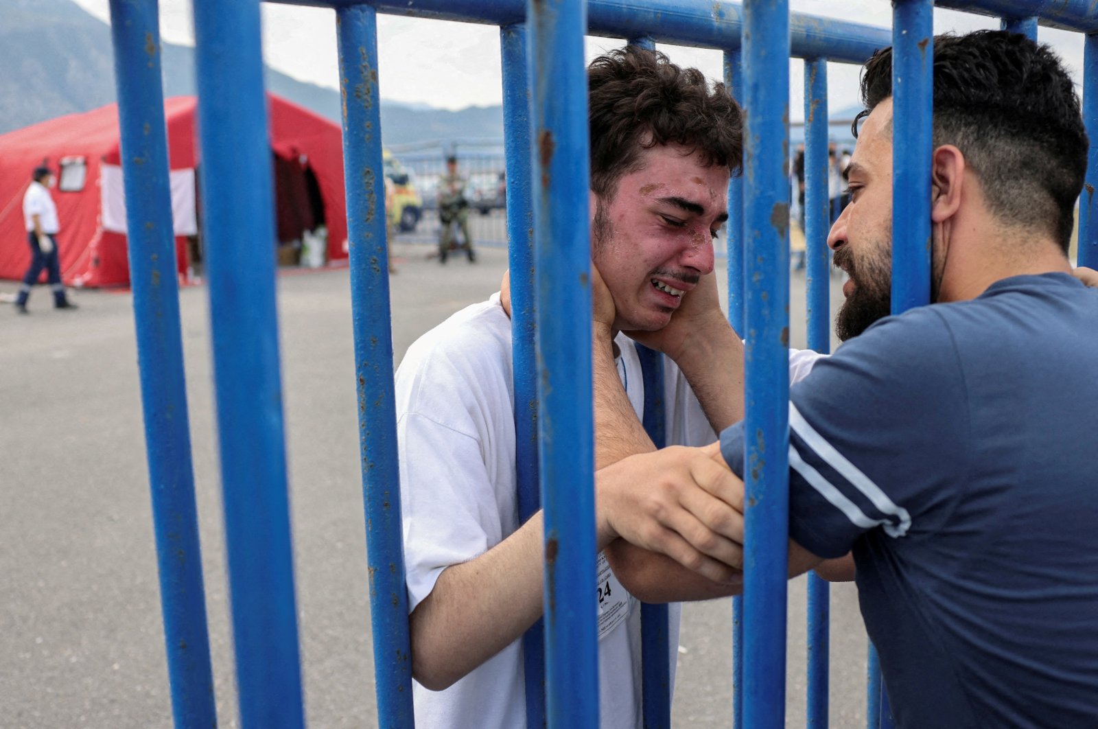 Syrian survivor Mohammad, 18, who was rescued with other refugees and migrants at open sea off Greece after their boat capsized, cries as he reunites with his brother Fadi, who came to meet him from the Netherlands, Kalamata, Greece, June 16, 2023. (Reuters Photo)