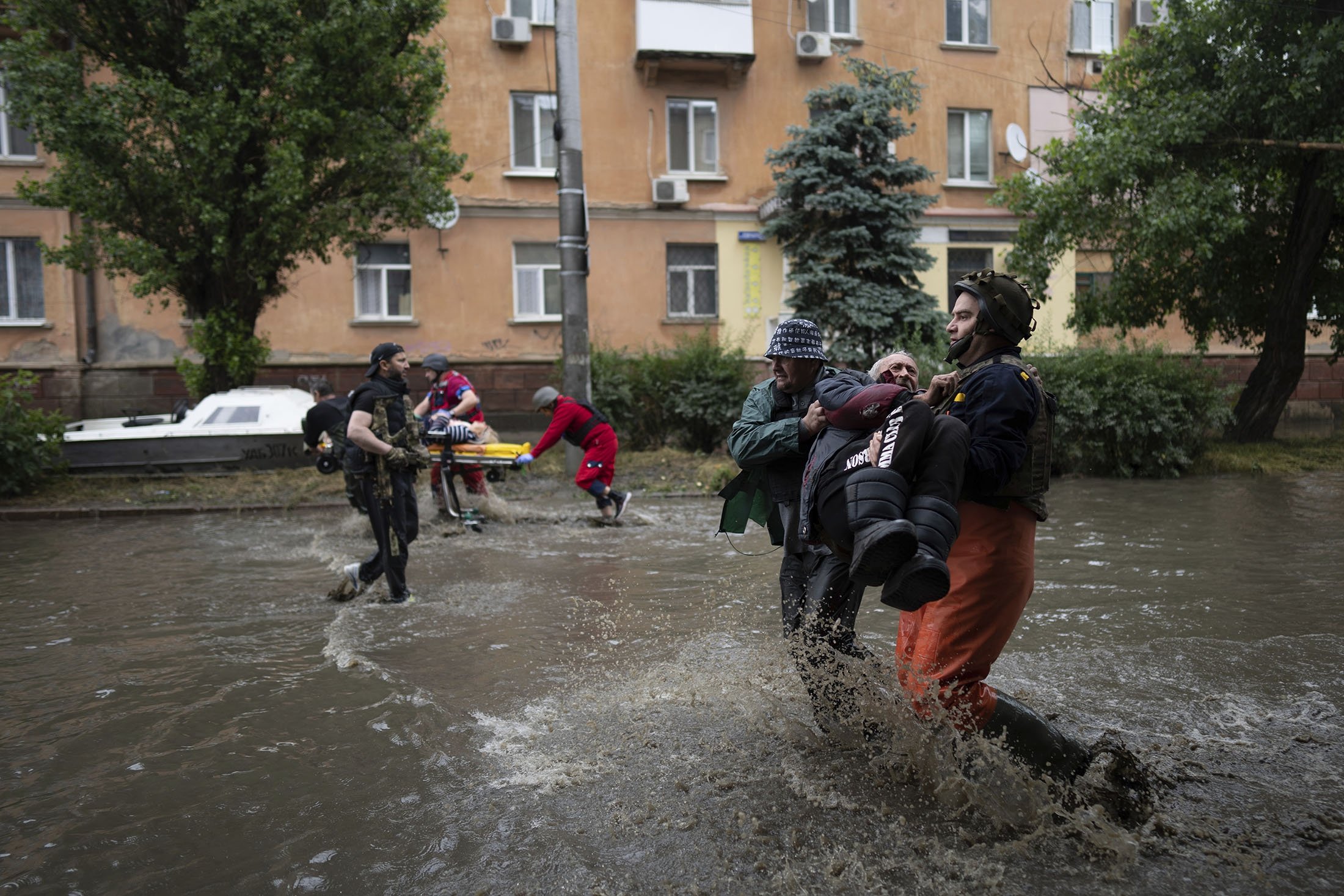 Tim darurat membantu menyelamatkan pengungsi yang terluka, di Kherson, Ukraina, 11 Juni 2023. (Foto AP)